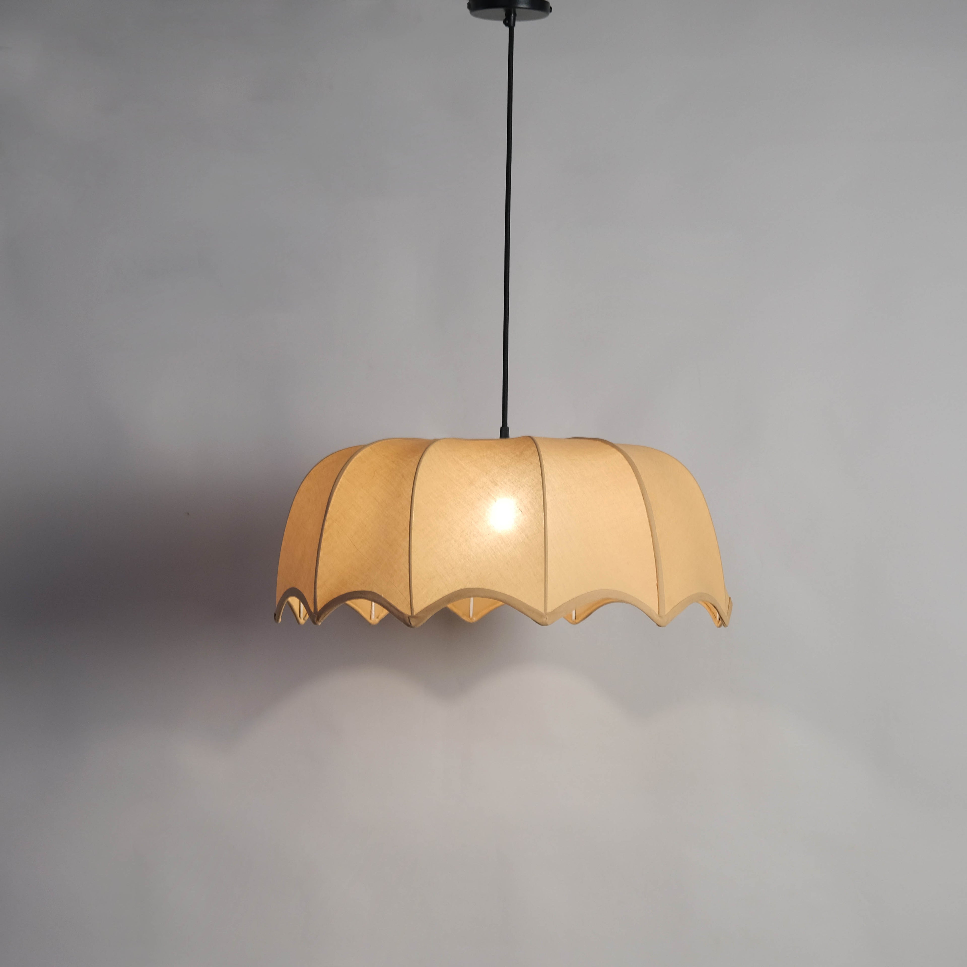 Adjustable cord fabric pendant light with a beige shade, ideal for versatile interior décor needs