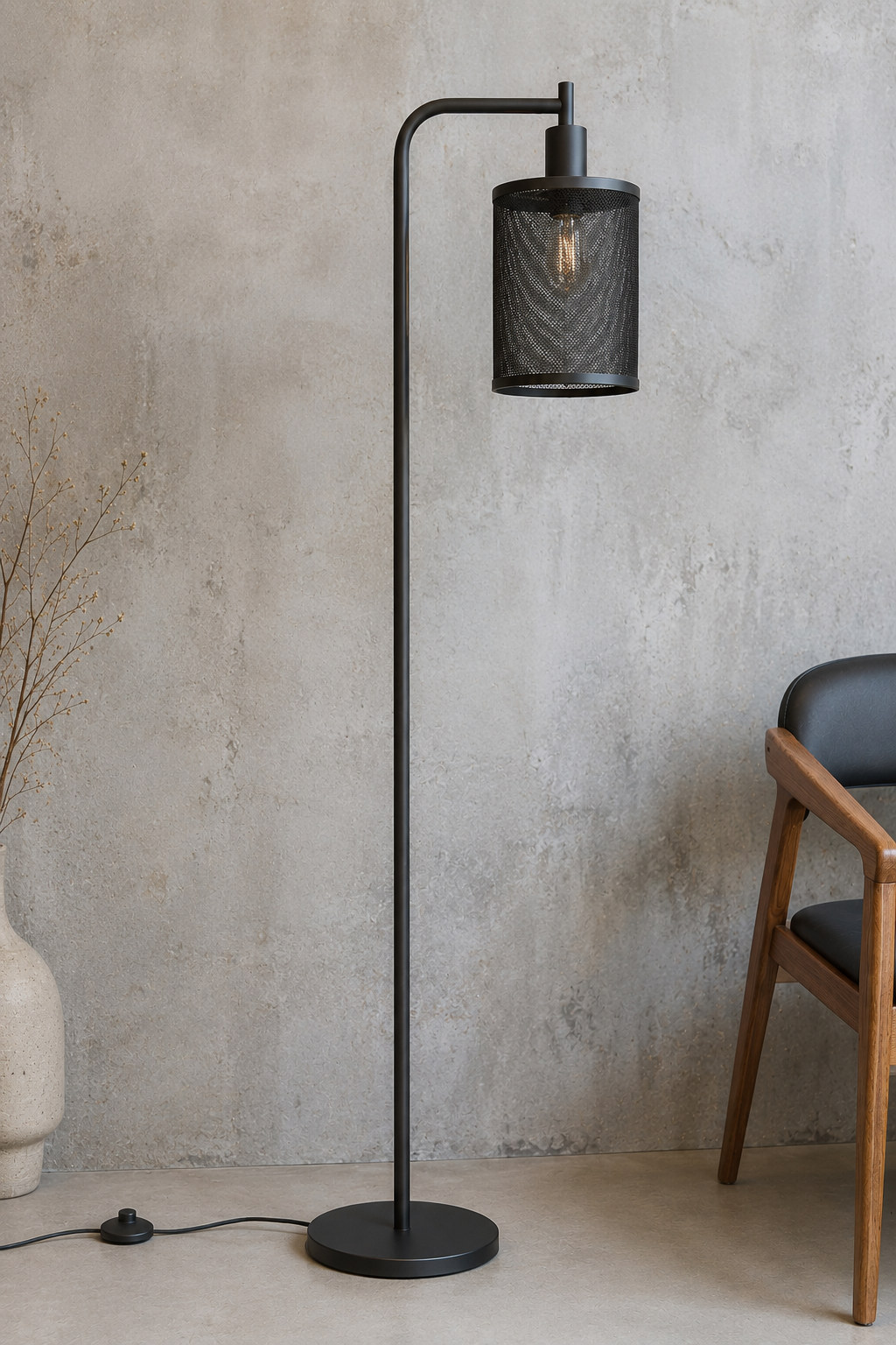 Black floor lamp against a textured wall with a chair and vase in the background.