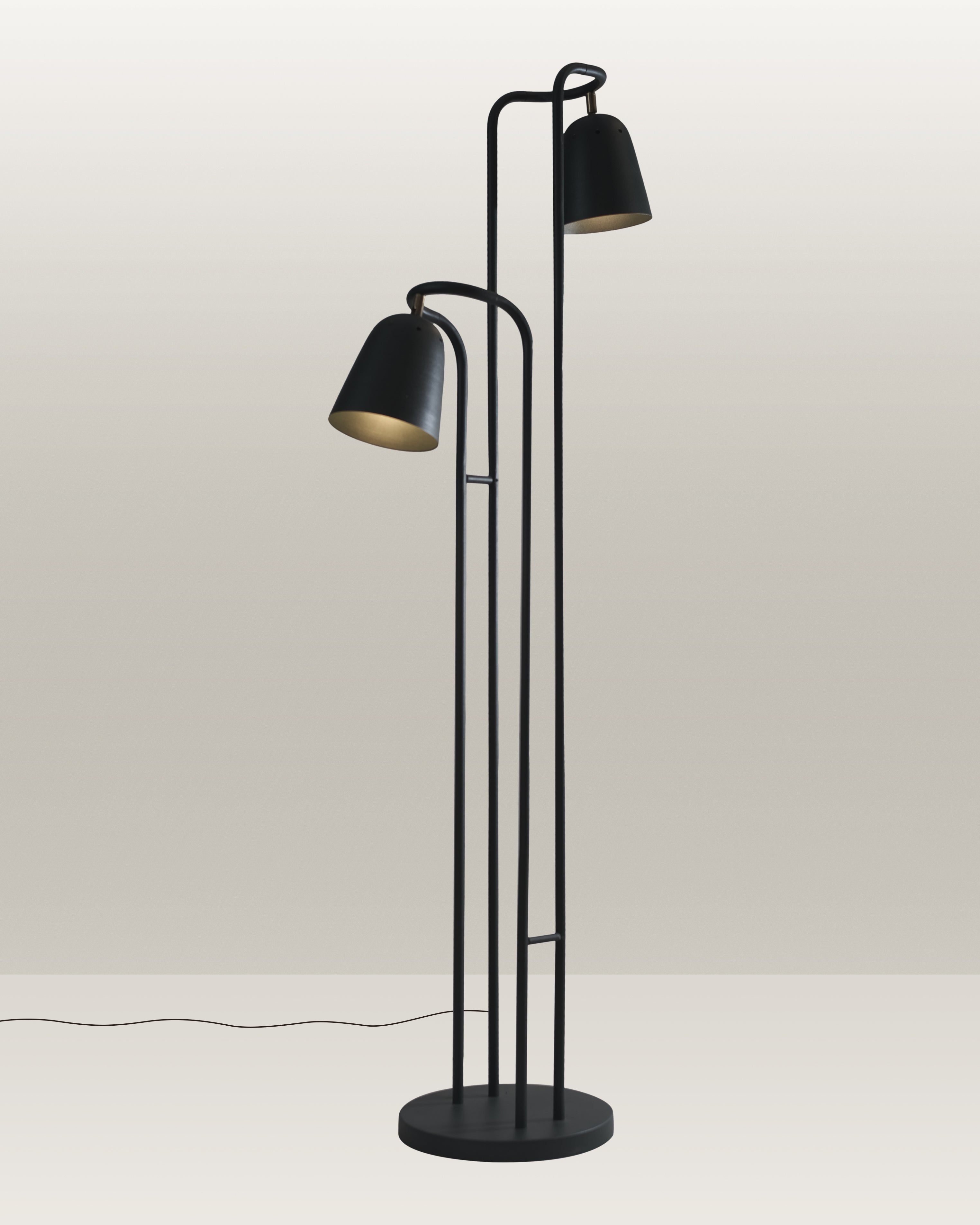 Black floor lamp with a streamlined silhouette and adjustable heads for directed illumination.