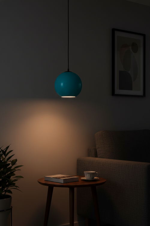Blue pendant light in a dimly lit room with a table and chair.