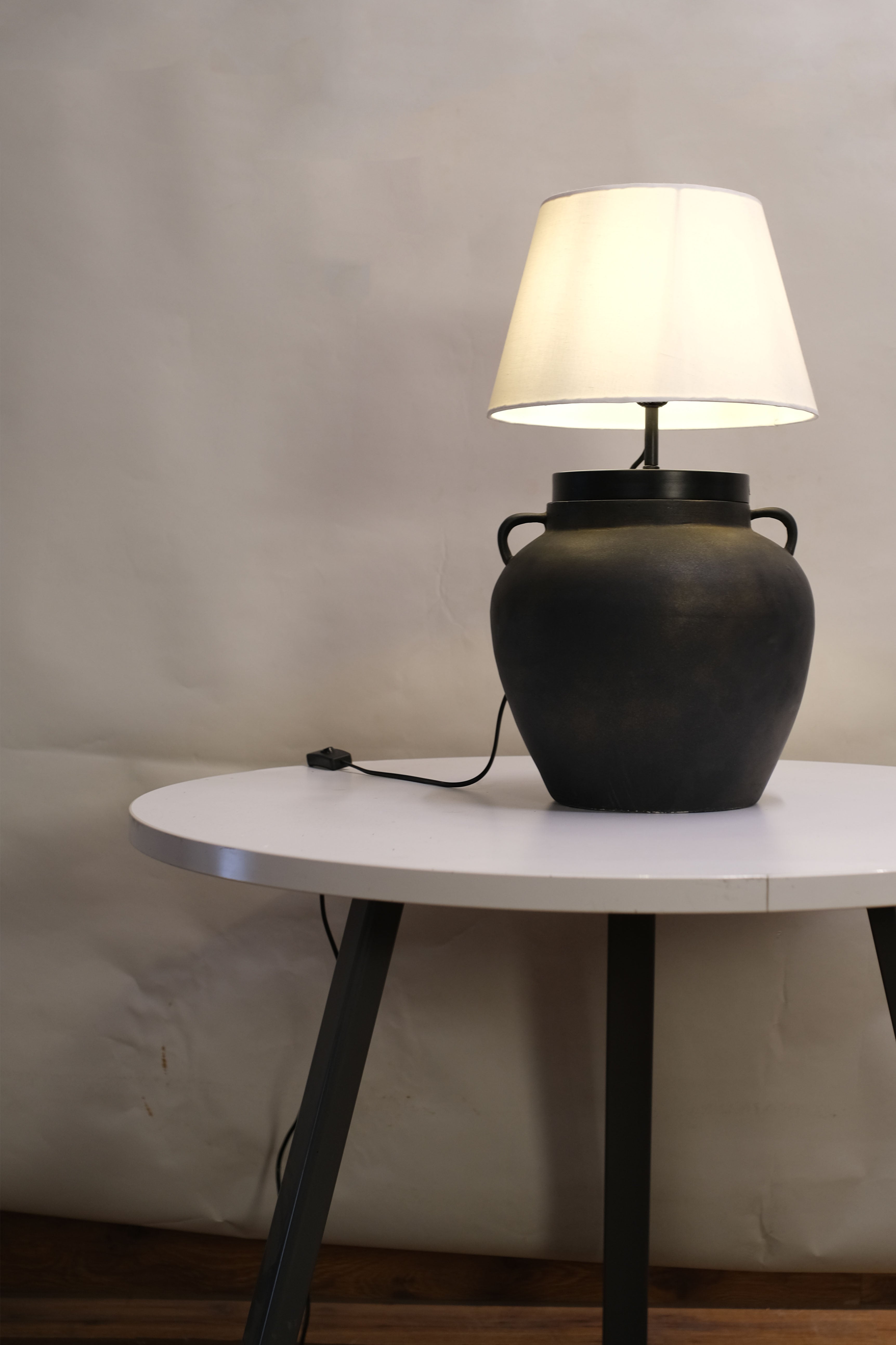 Bohemian table lamp showcasing a unique dune-inspired finish, casting a warm, inviting glow