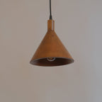 Brown pendant light hanging against a plain wall