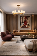 Modern living room with brown sofa, purple armchair, and abstract painting on wall.