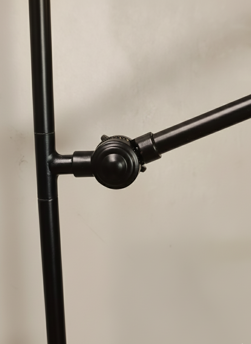 Close-up of a black metal stand on a beige background