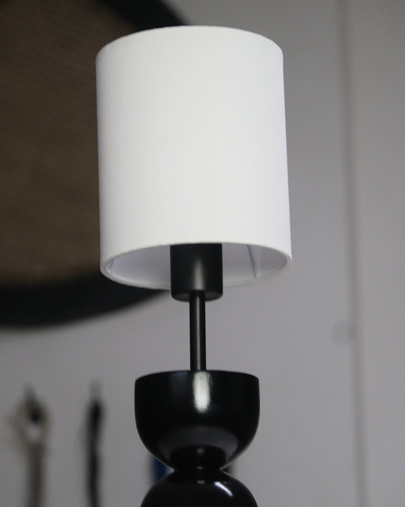 Compact and stylish table lamp showcasing a bold geometric base and clean white lampshade.