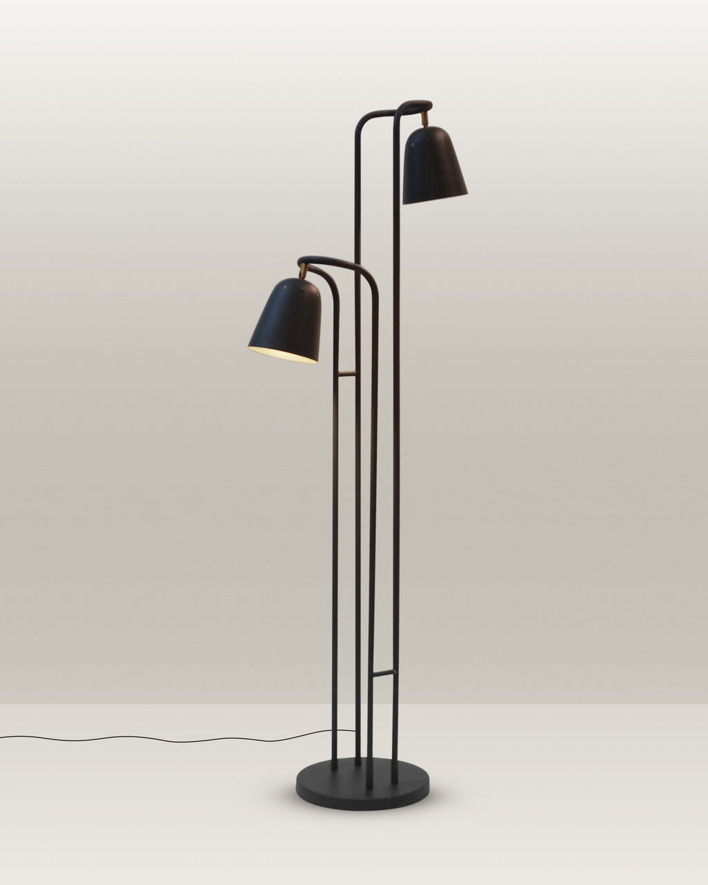 Contemporary floor lamp with a minimalist design and dual adjustable heads for versatile lighting.