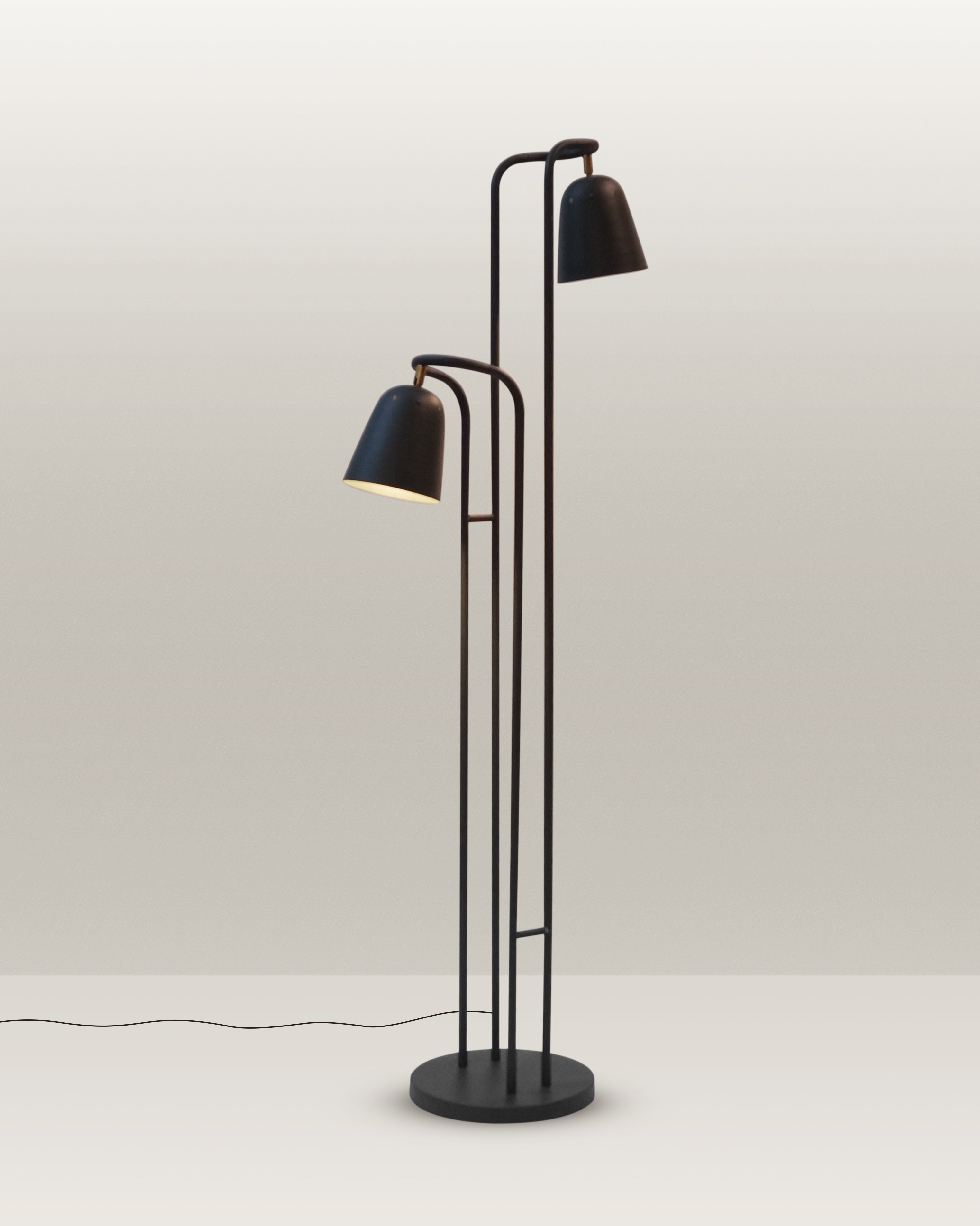 Contemporary floor lamp with a minimalist design and dual adjustable heads for versatile lighting.