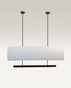 Edgy black rods suspend the luxe pendant dining light over a modern dining table.
