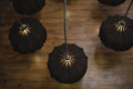 Elegant chandelier adorned with ornate glass designs, spreading soft light across a large ballroom.