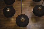 Elegant chandelier adorned with ornate glass designs, spreading soft light across a large ballroom.