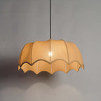Elegant fabric pendant light suspended from a sleek black cord, perfect for dining and living spaces.