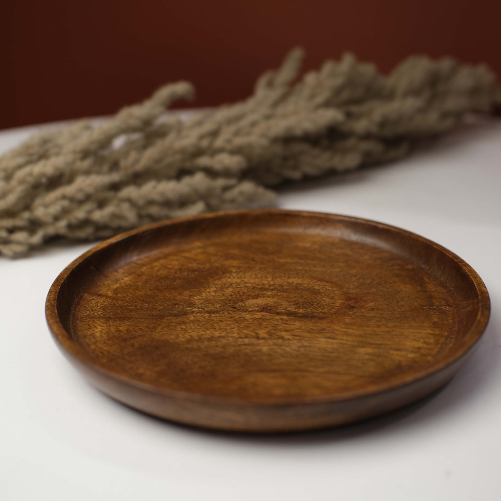 A stylishly decorated table featuring warm lighting, textured fabrics, and handcrafted accents for a cozy yet elegant setting.