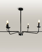 Minimalist chandelier featuring six black metal arms and candle flame light bulbs, illuminating a contemporary dining area.