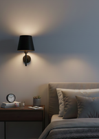 Modern bedroom with a bedside table and wall lamp.