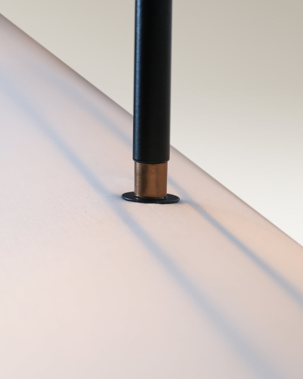 Modern dining room illuminated by an industrial luxe pendant light with black rods