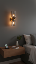 Modern wall sconce on a gray wall above a wooden nightstand with a smartphone and plant.