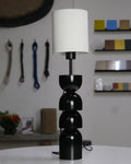 Sleek black and white table lamp with rounded segments and a modern minimalist design.