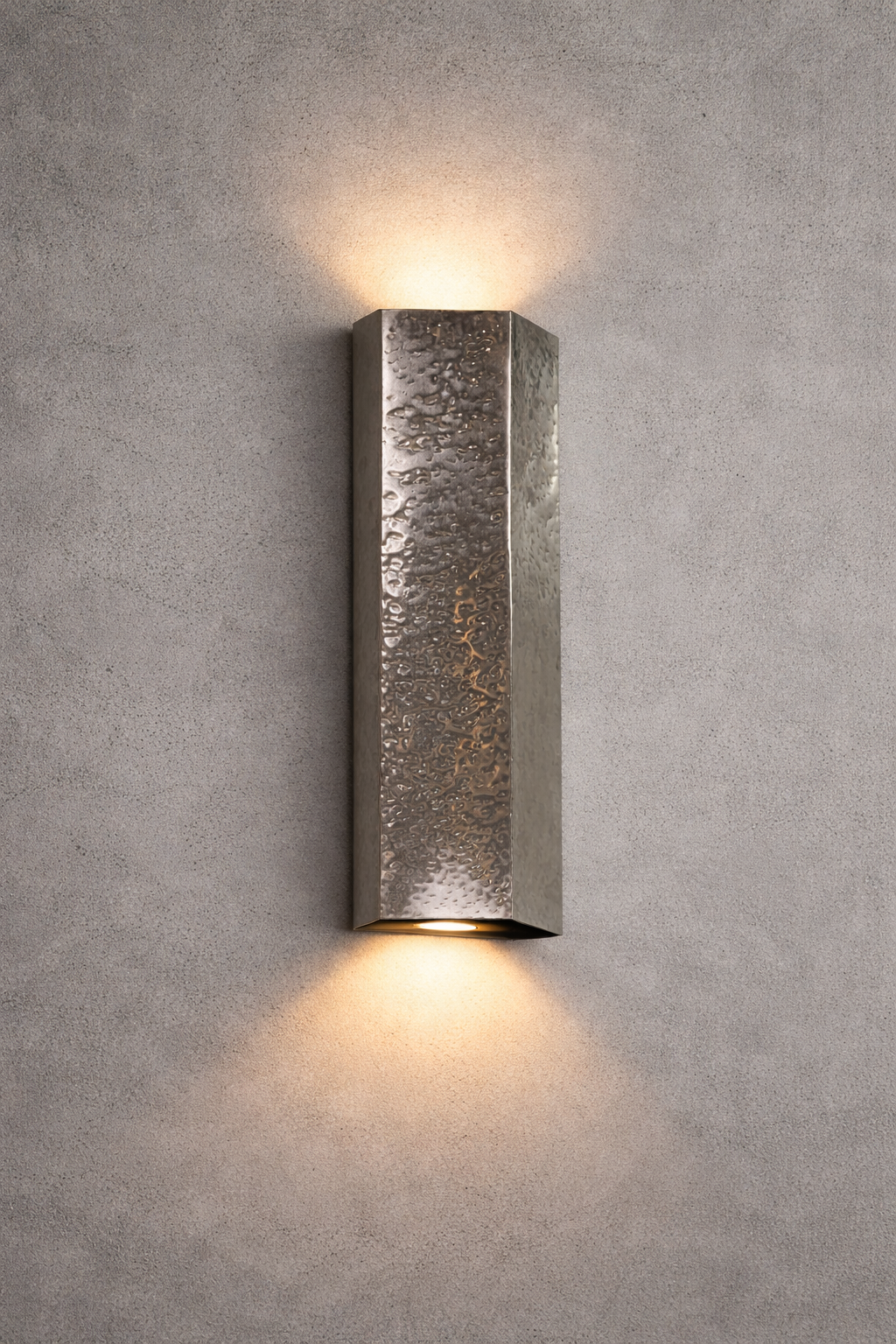 Textured wall sconce light fixture on a gray concrete wall