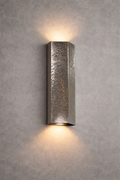 Textured wall sconce light fixture on a gray concrete wall