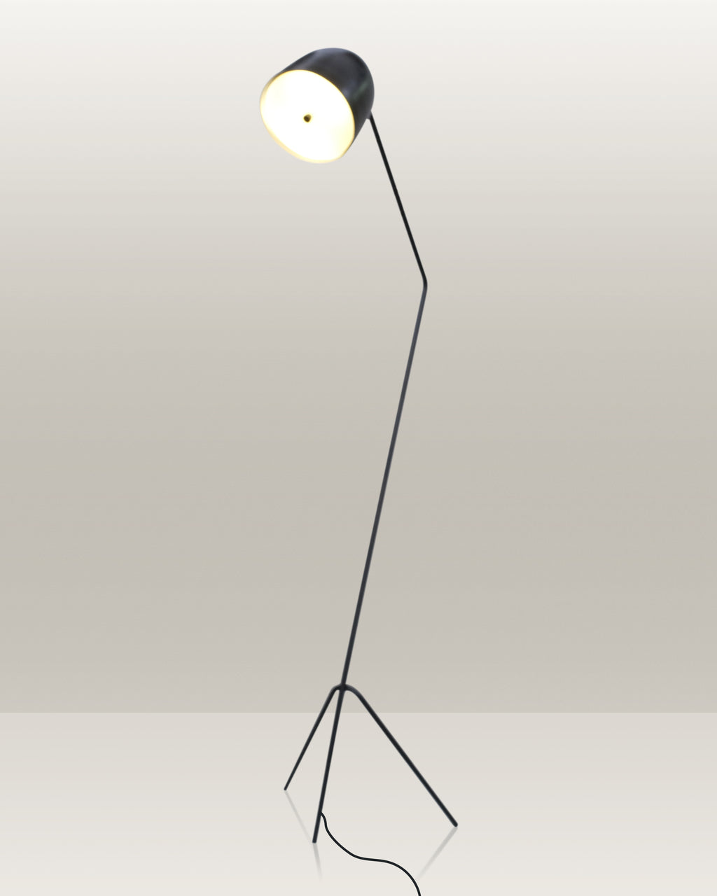 Stylish floor lamp with a tripod base and an adjustable head for directed illumination.