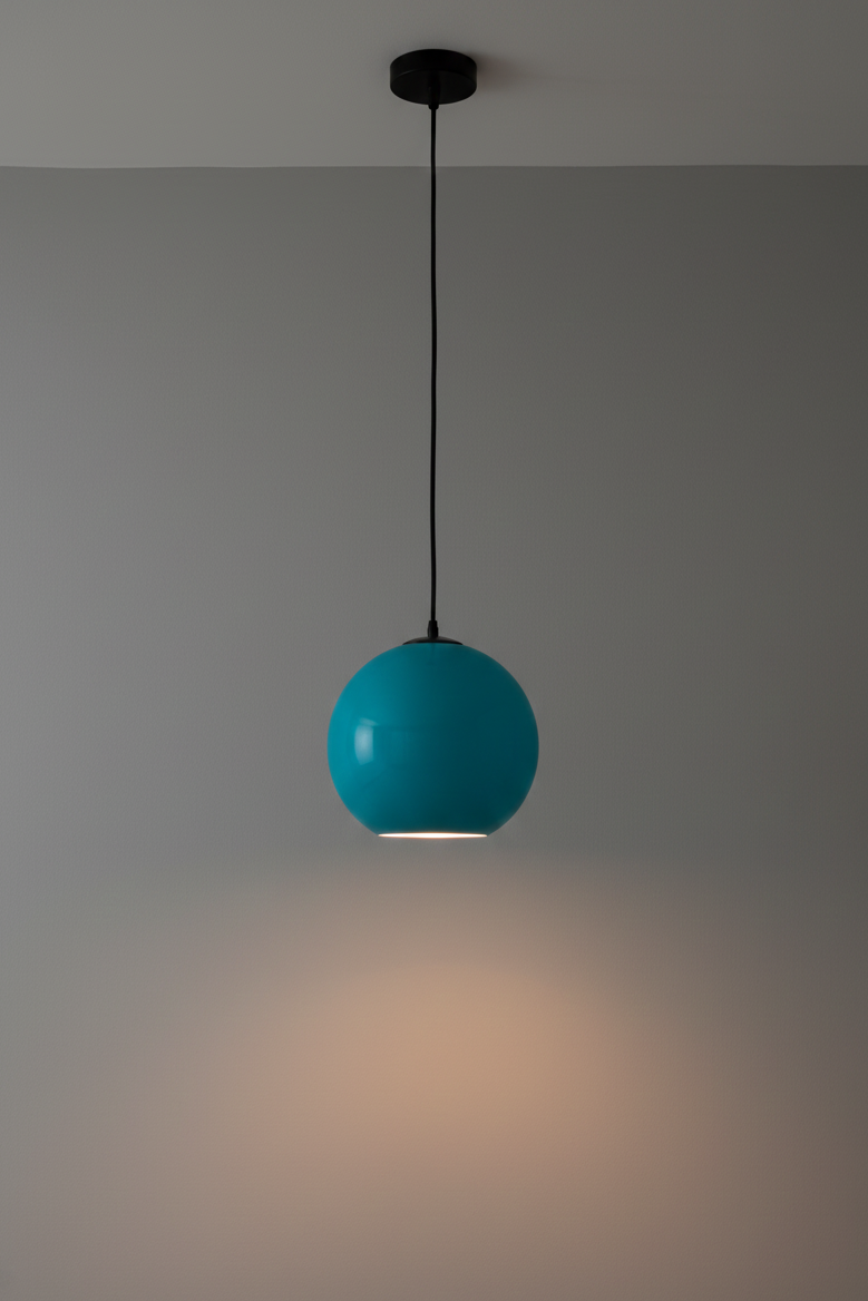 Turquoise pendant light hanging against a gray wall