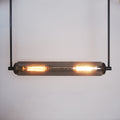 This modern lighting solution features an elongated glass tube encasing two glowing filament bulbs