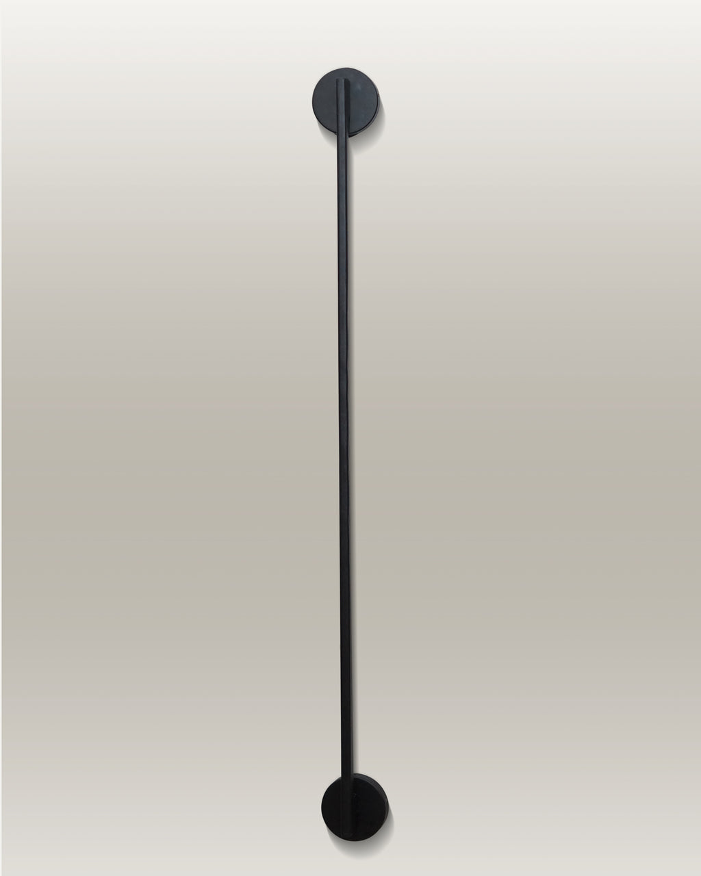 Vertical LED wall lamp with a sleek black finish, mounted with circular fixtures at the top and bottom ends.