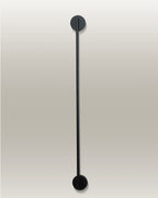 Vertical LED wall lamp with a sleek black finish, mounted with circular fixtures at the top and bottom ends.