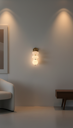 Wall-mounted light fixture in a modern room with a sofa and side table.