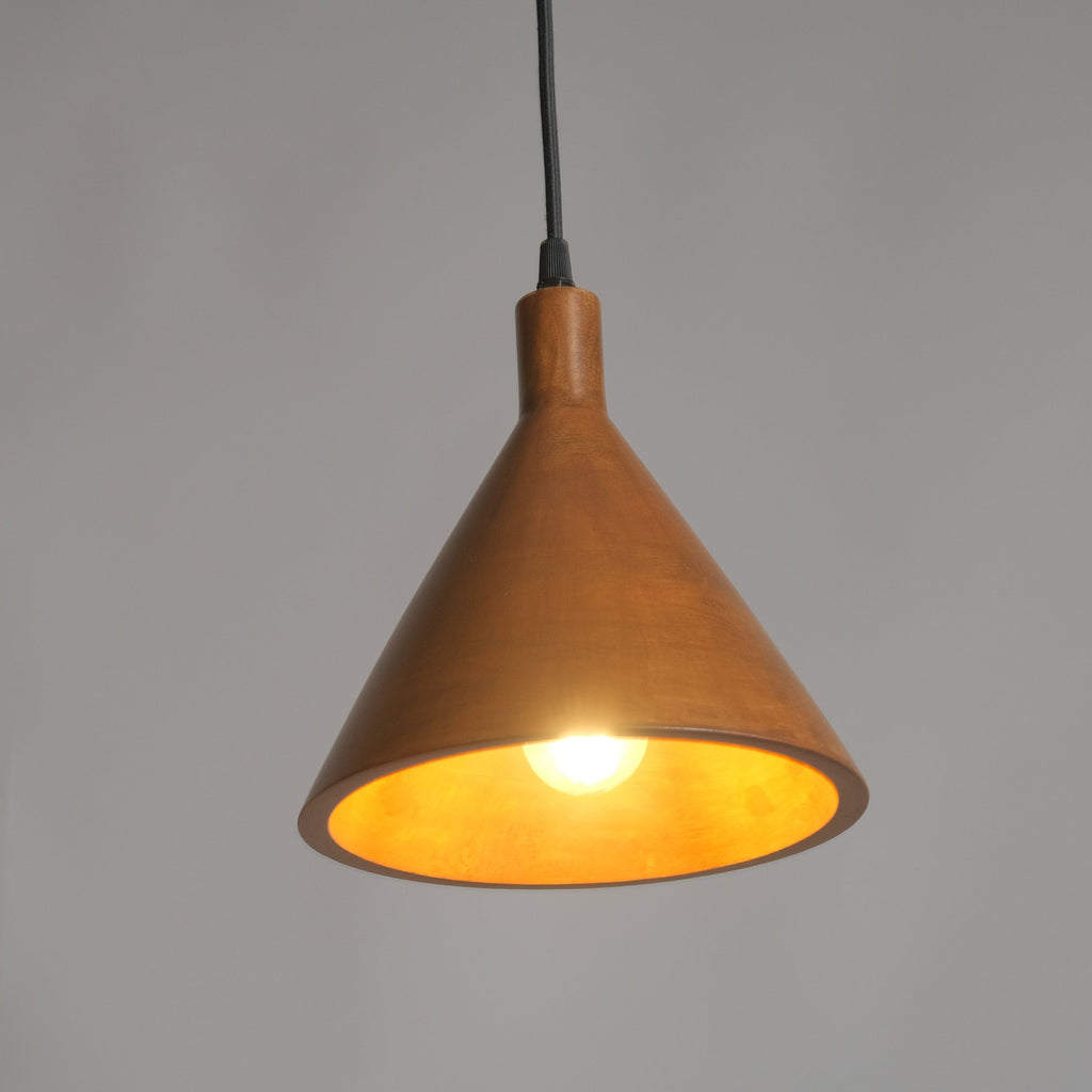 Wooden pendant light with a warm glow on a gray background