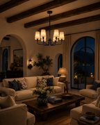 cozy living room with chandelier, couch and coffee table at night 
