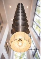 Modern pendant light with black steel design in a bright room