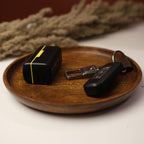 A minimalist table arrangement with rustic wood, chic metallic accents, and subtle floral touches