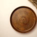 An industrial-chic tabletop setup with matte black accessories, vintage-inspired decor, and warm-toned lighting for a bold, sophisticated look.