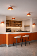 Modern kitchen with orange and white color scheme, featuring bar stools and a counter.