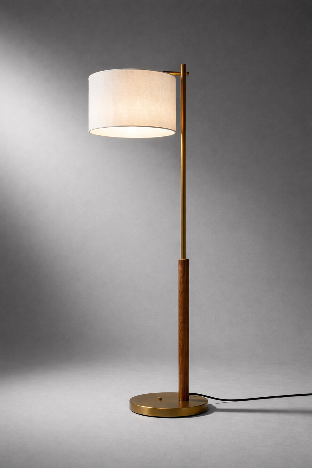Floor lamp with a white shade and gold base on a gray background