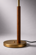 Table lamp with wooden and brass design on a gray background